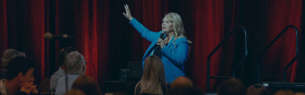 Photo of keynote speaker, Jody Carrington, on stage speaking at a conference.