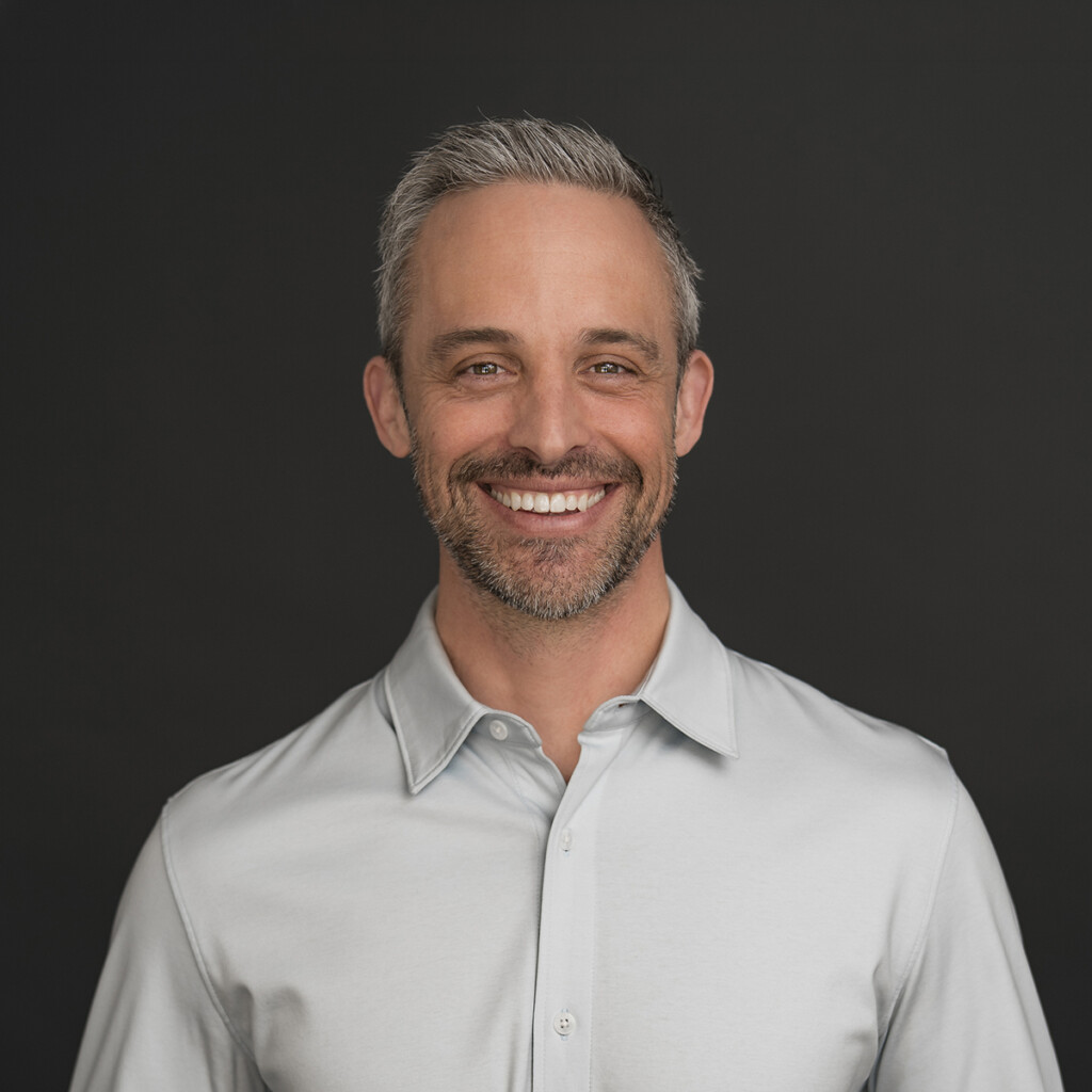 Professional Headshot for Sébastien Sasseville Headshot wearing a light grey shirt in front of a grey studio backdrop.